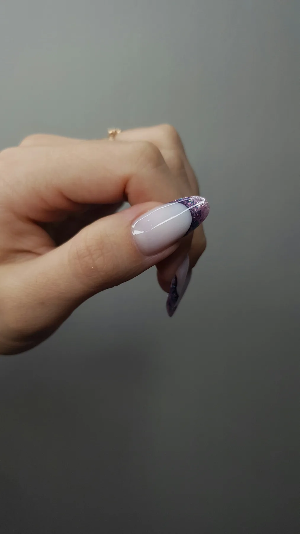 A french manicure with glitter accents