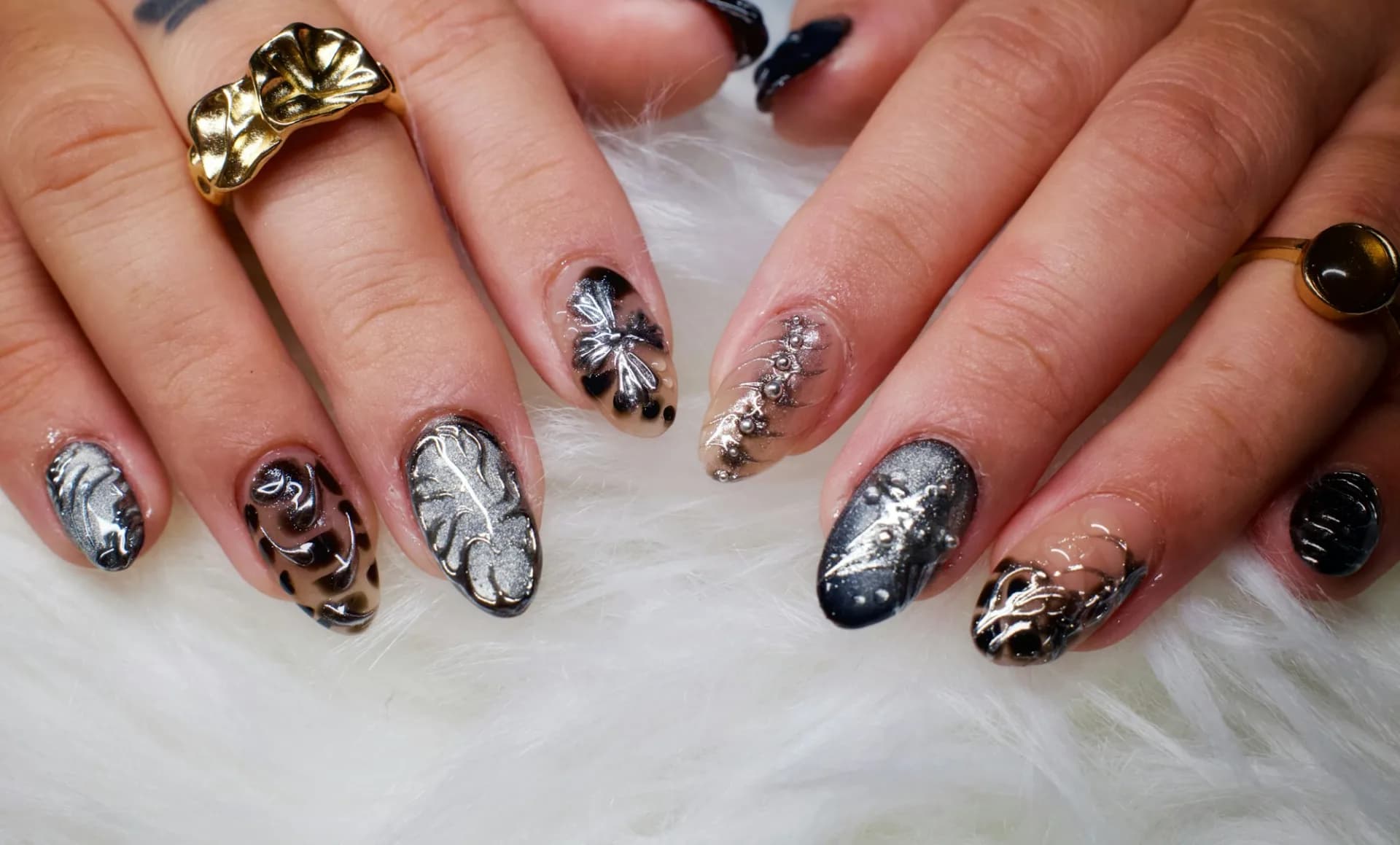 Hands with decorative leopard print and leaf nail art
