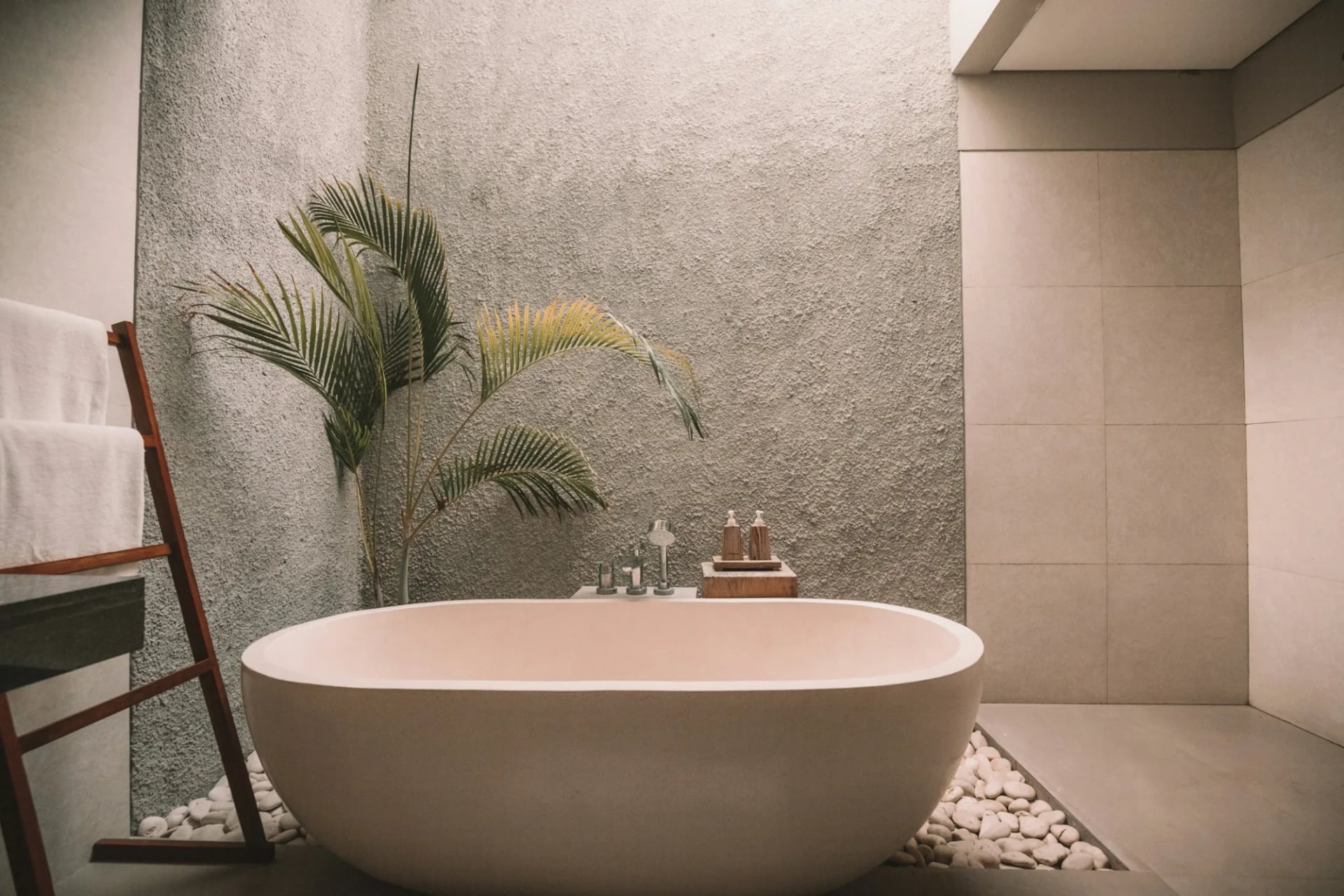A freestanding bath in a calm, sunlit spa room